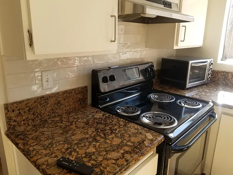 Electric stove, microwave, ceramic tile.