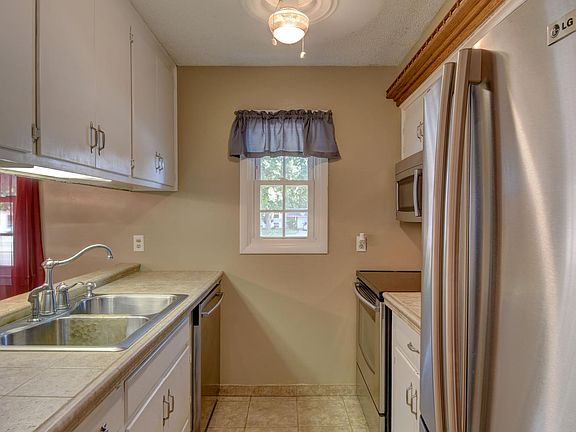 Stainless appliances in the kitchen with lots of shelvings.
