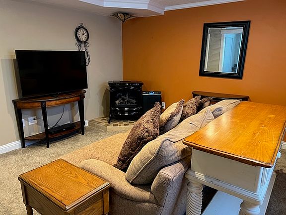 Cozy deep couch and large flat screen TV.