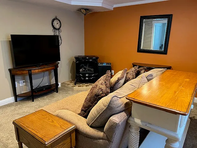 Cozy deep couch and large flat screen TV.