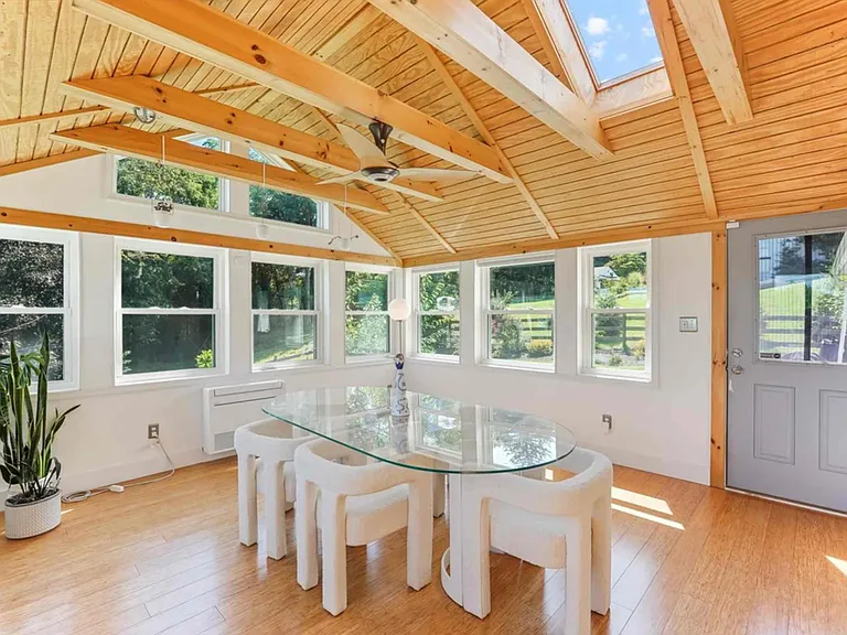 4 seasons room with seating for 6 and views of the backyard