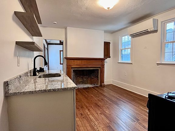 Kitchen with mini split and decorative fireplace