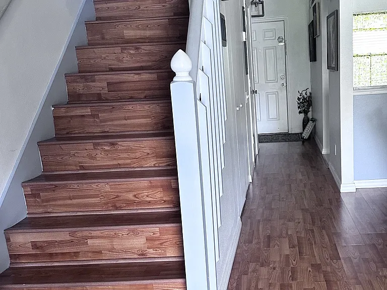 First floor with laminate flooring and hardwood stairs