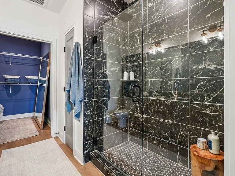 Bathroom with Granite Countertops, Double Vanity Sinks, Walk-in Shower, and Walk-in Closet