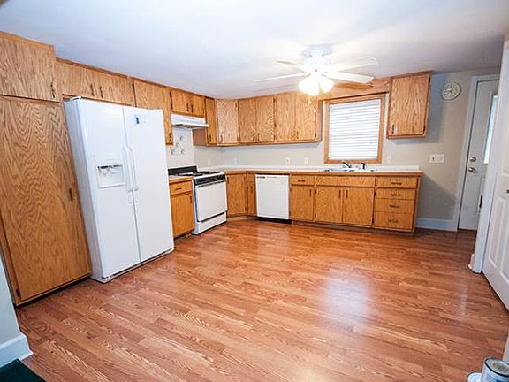 Large kitchen (17x12) with pergo laminate flooring and built in pantry The kitchen window offers a great view of the back deck and the back door entry leads into this space.  All kitchen appliances stay!