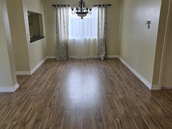 Dining room with new wood laminate flooring.