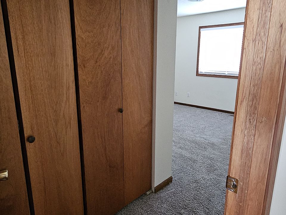 Primary bedroom offering large storage closets and en suite half bath.