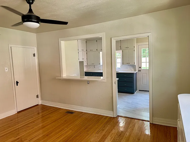 In dining room area, looking into kitchen