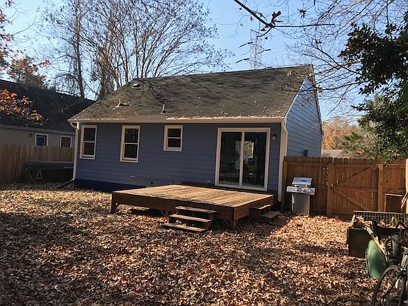 Back of house - fully fenced backyard is great for dogs. Sliding glass patio door lets in lots of sunlight.