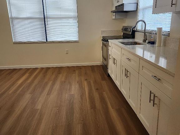 New kitchen cabinets, quartz countertop, glass Samsung electric range, new range hood, new garbage disposal, stainless steel sink, faucet.