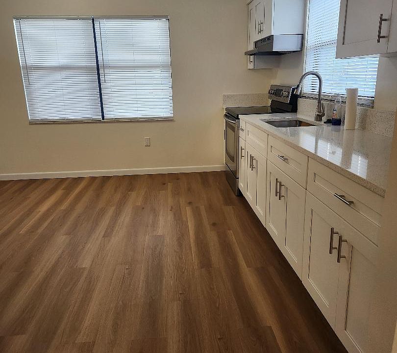 New kitchen cabinets, quartz countertop, glass Samsung electric range, new range hood, new garbage disposal, stainless steel sink, faucet.