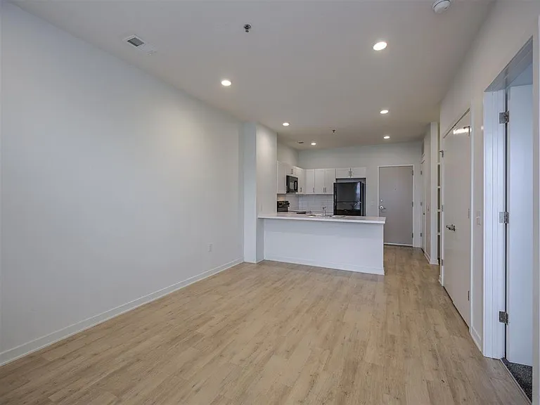 Large living room with white walls at The Rise.