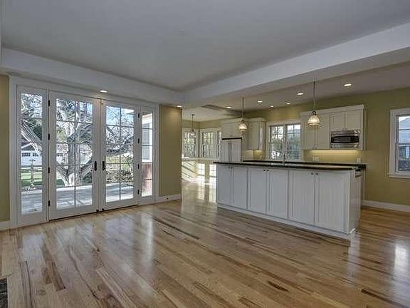 Family room with wood burning fireplace and folding doors to
