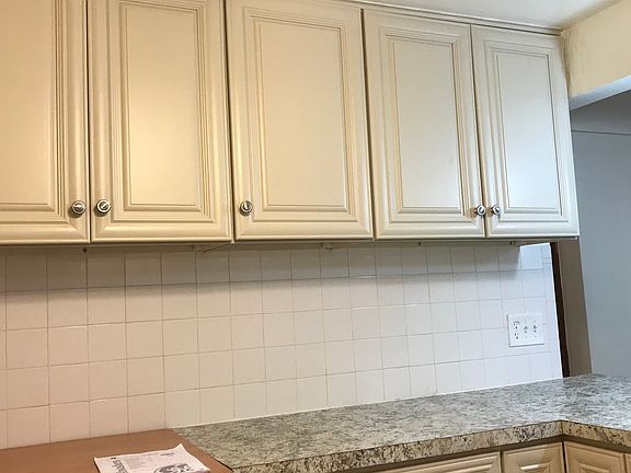 There is a large group of upper cabinets for kitchen storage