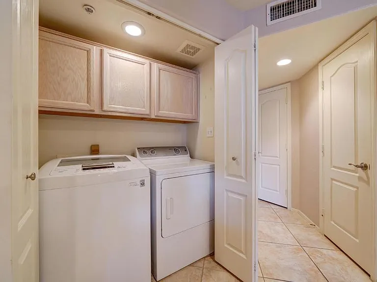 Full size side by side washer and new dryer December 2025. With storage above, vent and accordion doors to hide from view.
