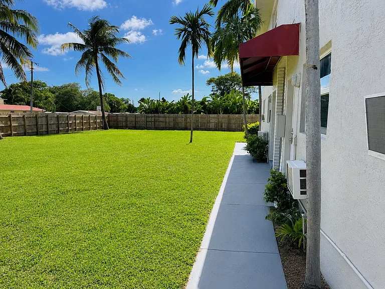 811 NW 6 Ave exterior 3 - fenced yard / building