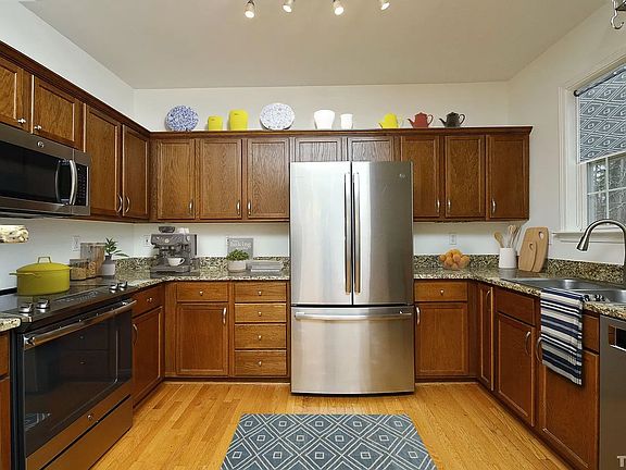 Kitchen across from dining area with view to the trees in the back. Main floor,