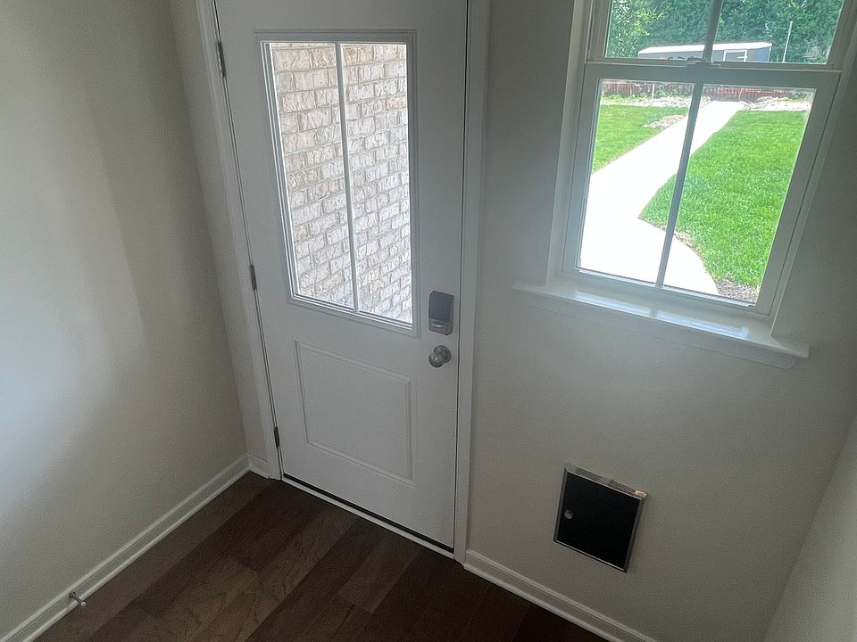 Entrance from front with wood floors. Comes with smart lock front door.