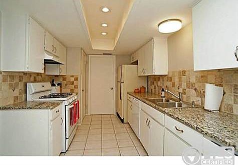 Updated kitchen has granite counters, tumbled marble backsplash,