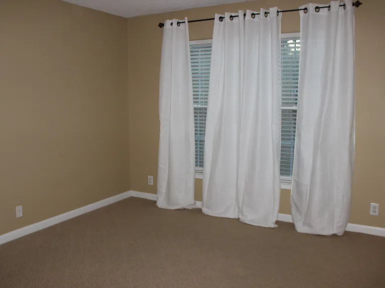 Guest bedroom fits a Queen size bed with one side stand comfortably