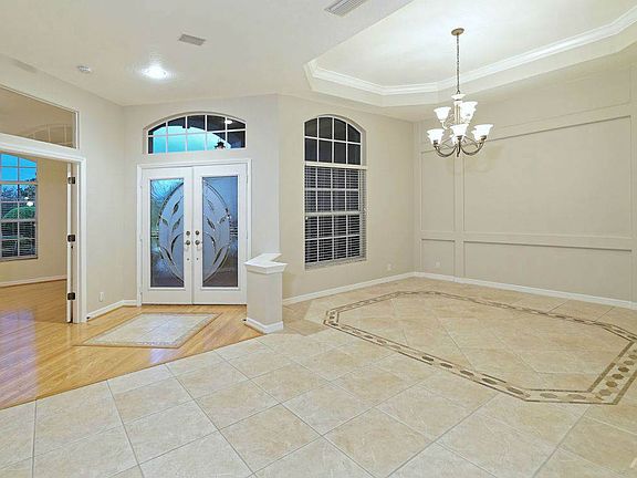 Once inside the home the custom features are easy to see. The formal dining room has custom walls, coffered ceilings and crown molding. Throughout the home you will find tile or wood flooring- NO carpet!
