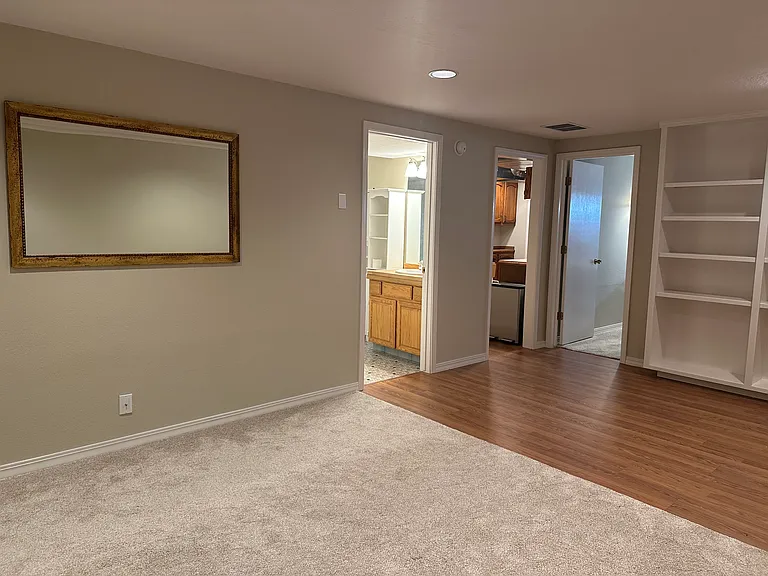 doors from left are bathroom, kitchen, bedroom