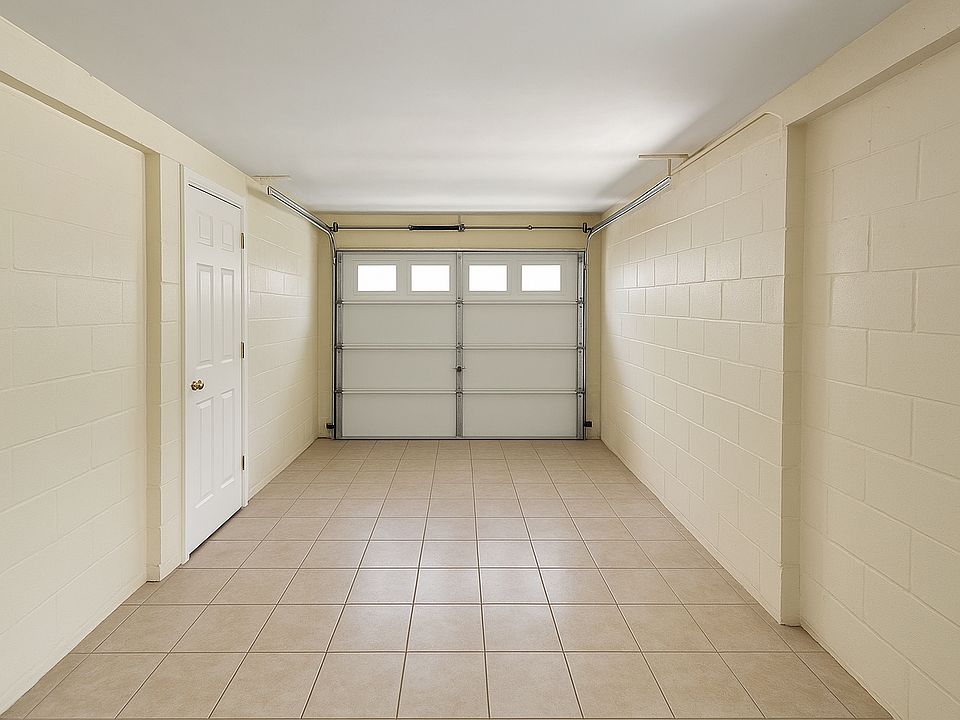 Garage has a door from the living room into the garage. Tiled floors and AC Vent for additional living space.
