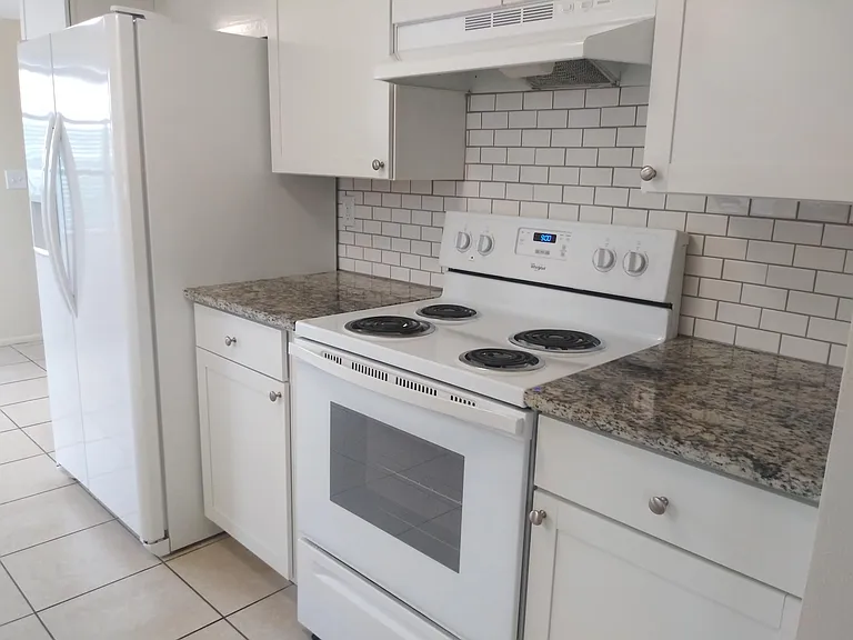 A bright and beautifully updated kitchen with granite counter tops.