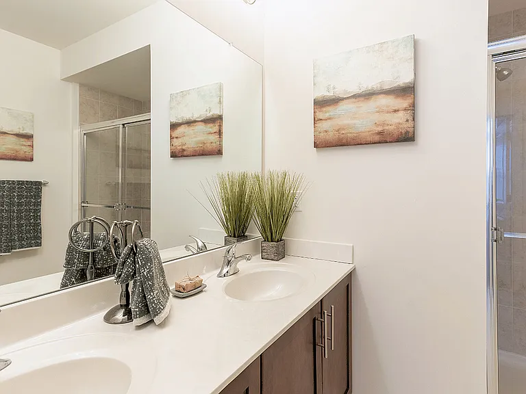 Spacious bedroom in a modern apartment featuring luxury carpeting, ample natural light, and a sleek, contemporary design for a comfortable and stylish retreat.
