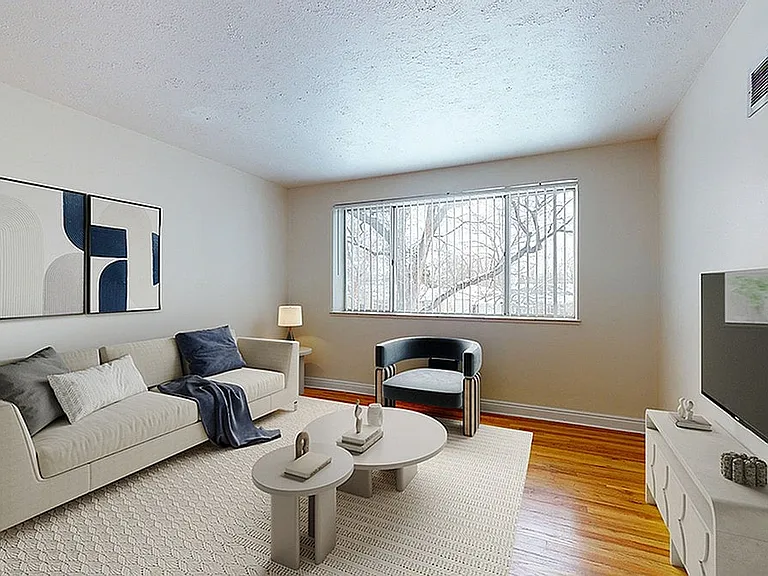 Bright and inviting living room with modern furniture, large window, and chic decor.