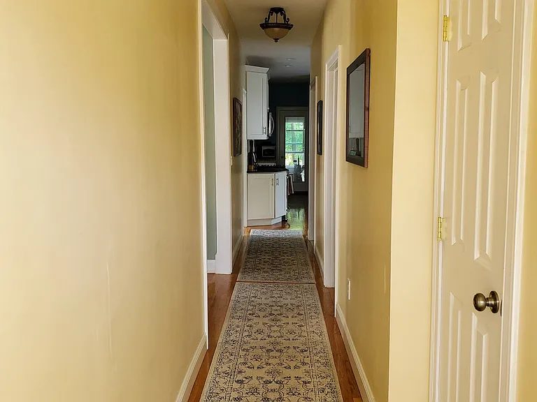 Hallway view from front door, door to right is a coat closet