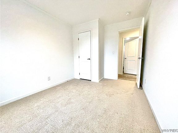 Bedroom number two has wall to wall carpeting and