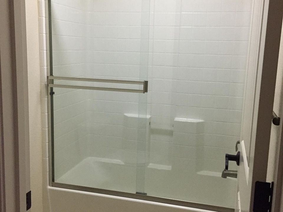hall bathroom has tub shower enclosure