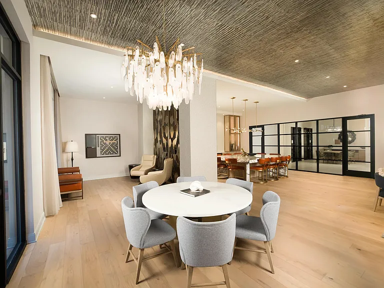 The thoughtfully designed dining and lounge space at Modera Liberty Row offers an inviting setting for shared meals, gatherings, and everyday connection.