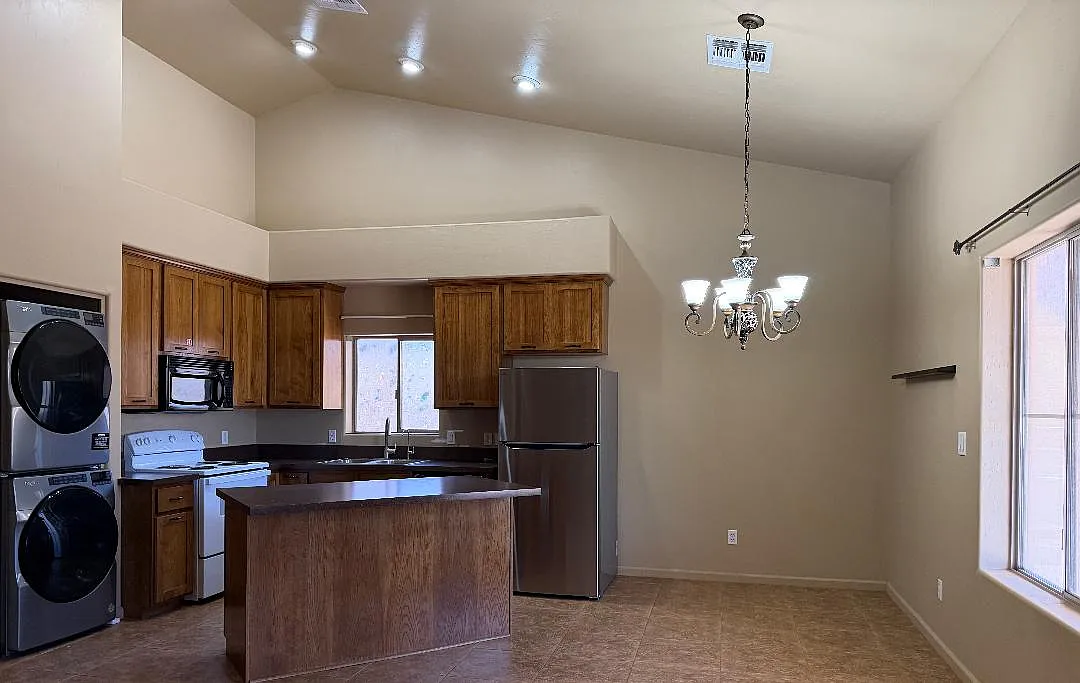 Kitchen, New Washer, New Dryer, New Refrigerator, Island with 6 large drawers, New Electric Oven/Stove, Dining Area with Chandelier, Large Window, New Wood Flooring, 15 ft. Ceiling. - 43208 N 20th St #A