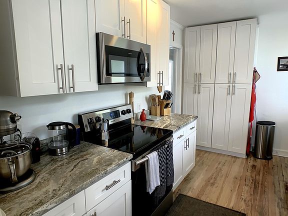 Large galley kitchen, with white shaker cabinets