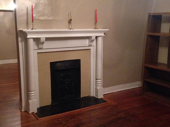 Living room mantel with brass decor
