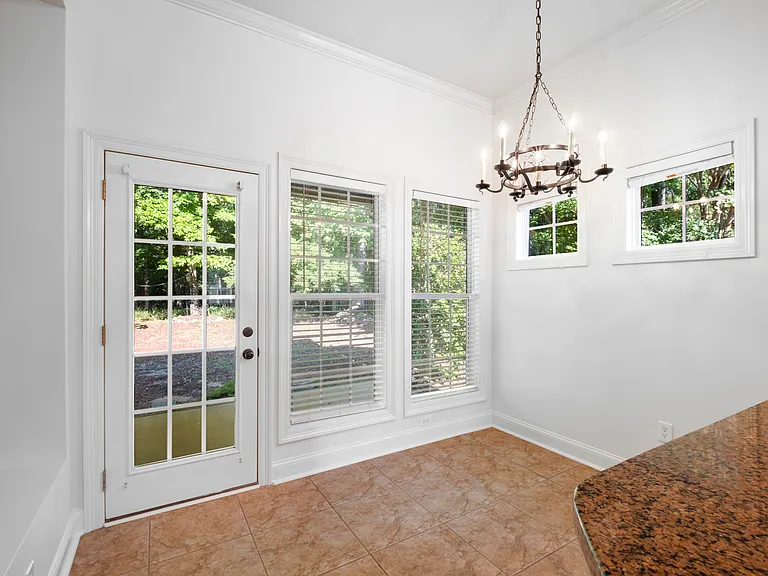 The breakfast room offers a number of windows and access to the rear porch.