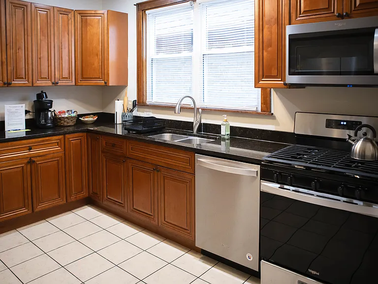 Kitchen has brand new stainless steel appliances including a refrigerator, dishwasher, stove/oven and over-the-range microwave.
