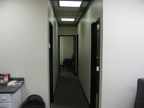 Hallway leading to 2 private offices and large workspace