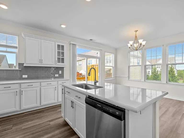 Enjoy the sunset view, and walk out onto back deck from sliding glass doors. Large kitchen area can easily fit full dining room set.