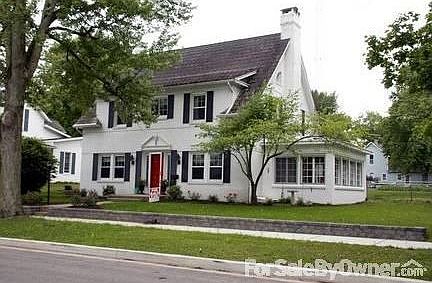 A classic colonial style with a new retaining wall, new grass, & new landscaping