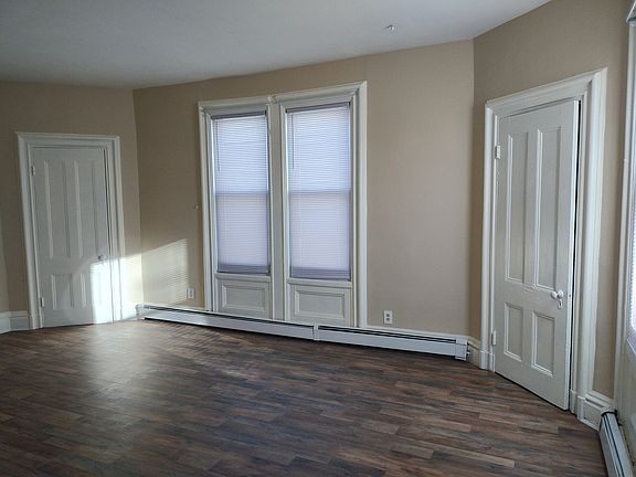 Living room. Two closet doors in photo.