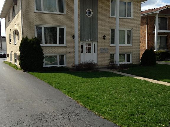 Street view driveway leads to parking lot behind buiding