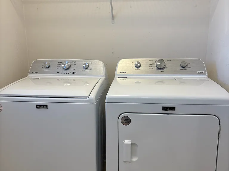 laundry room with brand new washer and dryer