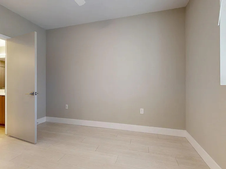 Spacious apartment Bedroom with Wood-Style Flooring.