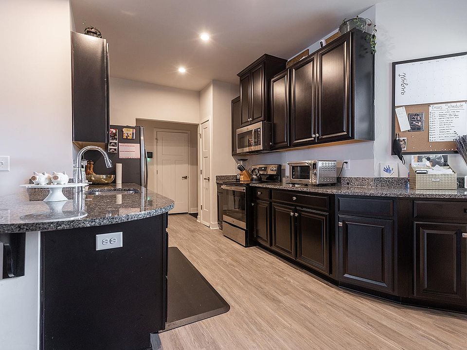 Through the kitchen is the laundry , half bath and garage
