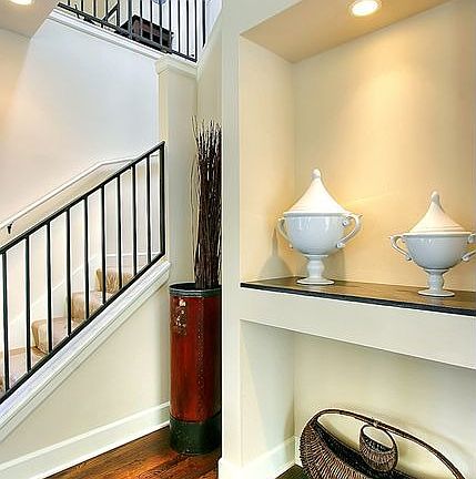 Art niche and custom iron railings on staircase.