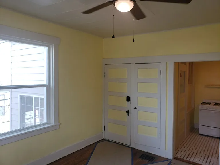 Living room. Front door and one of the coat closets.