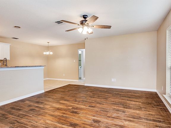 Living area opens to kitchen and dining area. Flooring is luxury vinyl plank.